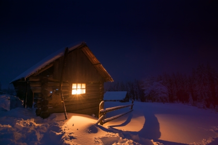 wooden house in winter forestの写真素材