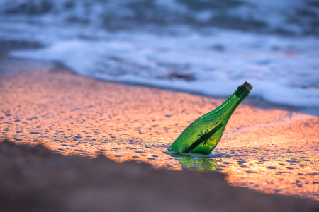 bottle with letter in sea waterの写真素材
