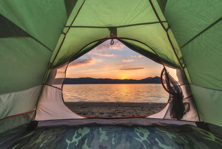 green tent on lake coastline closeupの写真素材