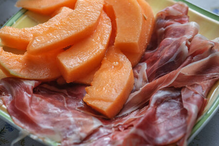 melon and prosciutto on plateの写真素材