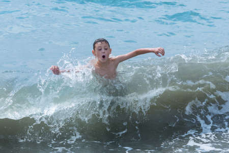 small boy swimming in sea
