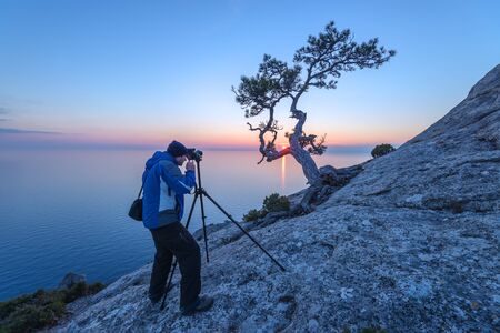 photographer on the morning seascape
