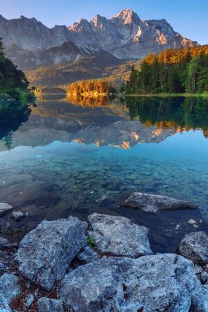 Fantastic sundown on mountain lake Eibsee, located in the Bavaria, Germany. Dramatic unusual scene. Alps, Europe.の写真素材