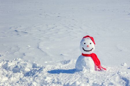 snowman santa on snowy fieldの写真素材