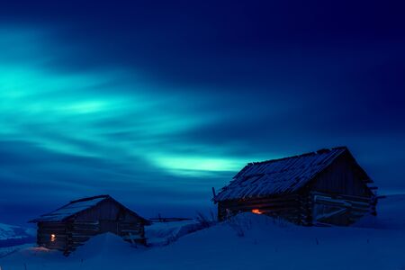 wooden house in winter forestの写真素材
