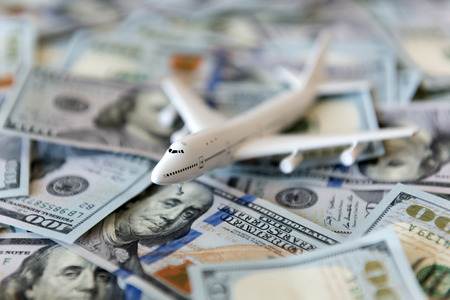 white plane on dollar cash closeup