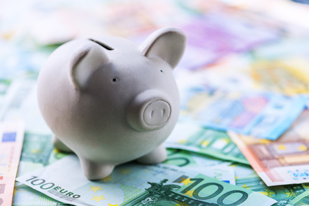 pig money box with cash closeupの写真素材