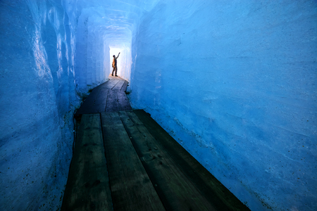 Man silhouette in ice cave. Rhone glacier, Switzerland, Europe.の写真素材