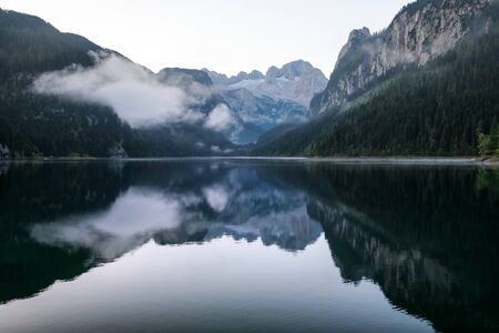 Fantastic morning on mountain lake Gosausee, located in the Austia. Dramatic unusual scene. Alps, Europe.の写真素材