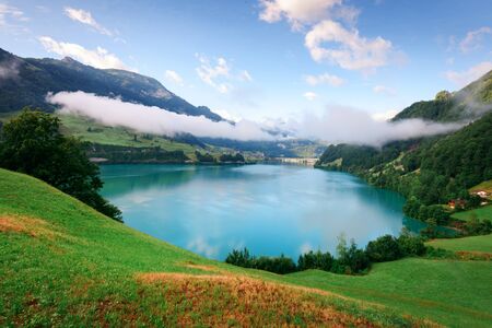 Amazing view of the Lungerersee lake in the morning mist. Lungern village, Switzerland, Europe.の写真素材