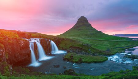 Colorful sunrise on Kirkjufellsfoss waterfall. Iceland, Europe.の写真素材