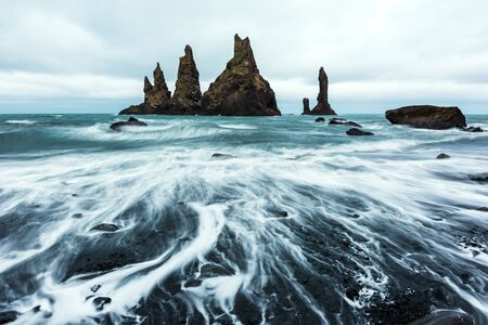 Basalt rock formations "Troll toes" on black beach. Reynisdrangar, Vik, Icelandの写真素材
