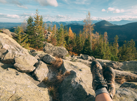Resting tourist legs in hiking bootsの写真素材