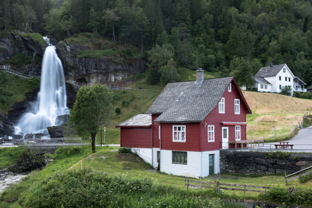 Red house near Steinsdalsfossen waterfallの写真素材