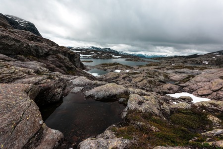 Typical norwegian landscape with snowy mountainsの写真素材