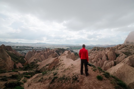 Amazing day in Cappadocia mountains, Turkey. Photographer stay on red rose valley in expectant of...