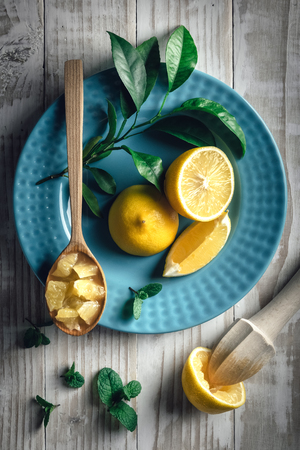 Lemon pieces on blue plate closeup. Healthy diet vitamin concept. Food photographyの写真素材