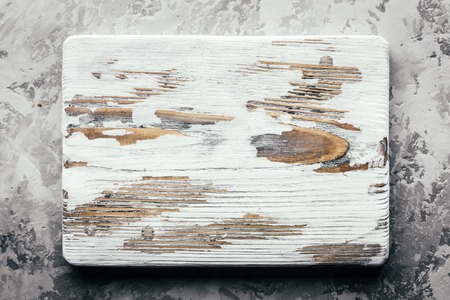 Old rustic white wood board on rustic concrete table. Food photographyの写真素材