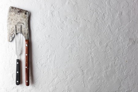 Old rustic axe for meat on a wooden board on grunge background. Food photographyの写真素材