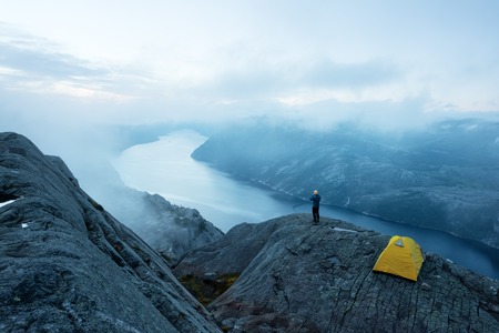 Alone tent near Trolltunga rock - most spectacular and famous scenic cliff in Norwayの写真素材