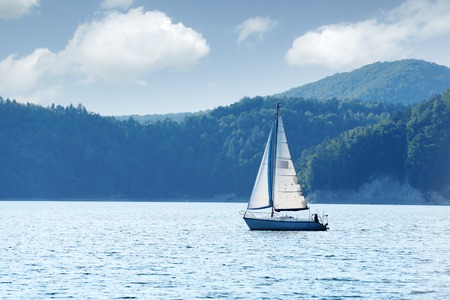 White yacht on Solina lake, Poland. Landscape photographyの写真素材