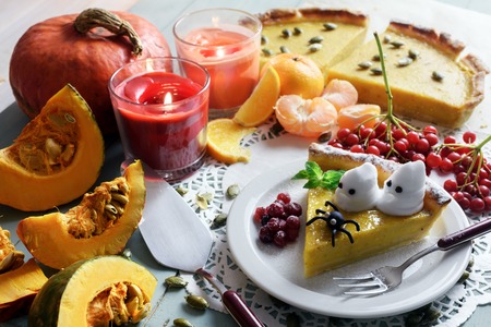 Pumpkin cake, cooked for the celebration of Halloween and decorated with little ghosts. Food photographyの写真素材