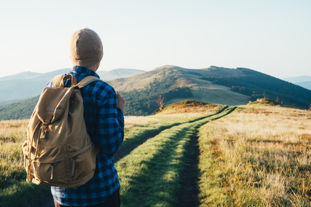 Man with backpack on mountains road. Travel concept. Landscape photographyの写真素材