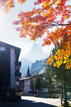 Picturesque view of Zermatt city street with Matterhorn peak and yellow ash tree in Swiss Alps. Switzerland, Europe. Landscape photographyの写真素材