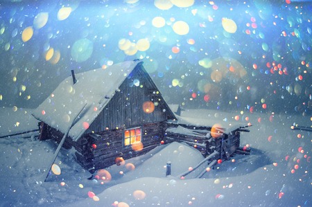 Fantastic winter landscape with wooden house in snowy mountains.