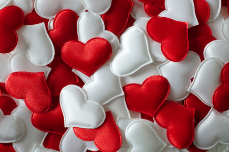 Red and white textile hearts closeup. Valentines day background, creative texture and love conceptの写真素材
