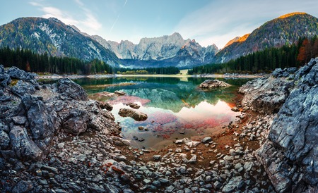 Colorful sunrise on Fusine lake. Picturesque autumn scene with Mangart peak on background. Julian Alps, Udine Province, Italyの写真素材