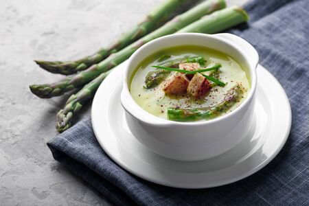 Asparagus soup in white bowl closeup. Food photographyの写真素材