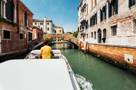 Venice, Italy - August 8, 2014: trip to old venetian canal on motor boatのeditorial素材