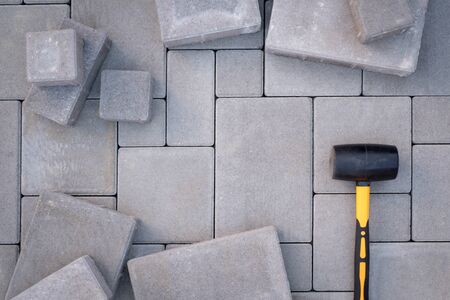 Paving stones paving background. Installing tools on foregroundの写真素材