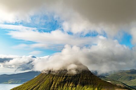 Foggy mountain peaks and clouds covering sea and mountains. Panoramical view from famous place -...