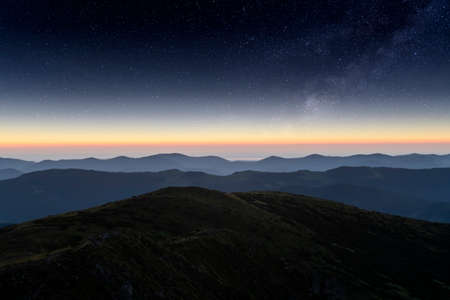 Mountains range against the backdrop of an incredible starry sky. Amazing night landscape with Milky Way. Tourism conceptの写真素材