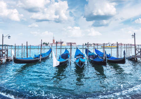Colorful landscape with clear blue sky on piazza San Marco in Venice. Row of gondolas parked on city pier. Church of San Giorgio Maggiore on background, Italy, Europeの写真素材