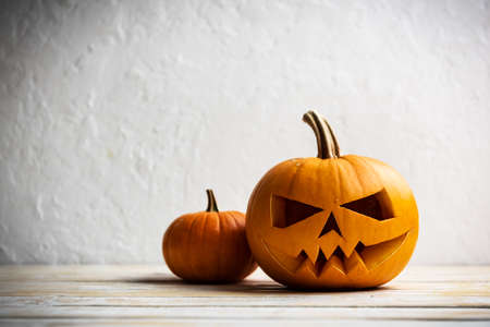Two pumpkins on wooden table. Halloween and autumn food backgroundの写真素材