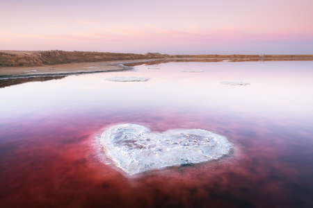Heart from salt in pink water salt lake in Ukraine, Europe. Creative conceptの写真素材