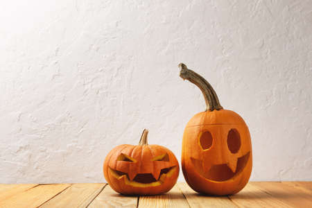 Two pumpkins on wooden table. Halloween and autumn food backgroundの写真素材