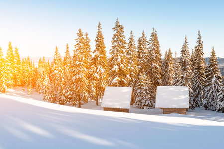 Fantastic winter landscape with wooden house in snowy mountains. Christmas holiday conceptの写真素材