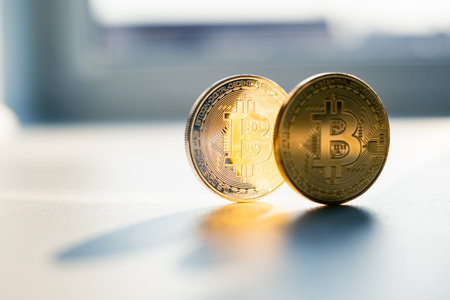 Golden bitcoin coins on white table closeup. E-business cryptocurrency conceptの写真素材