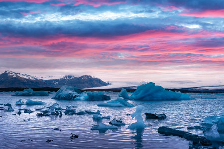Pink sunset and icebergs in Jokulsarlon glacial lagoon. Vatnajokull National Park, southeast...