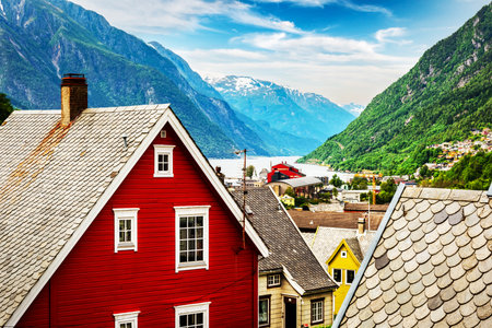 Typical norwegian houses near fjord and snowy mountains. Norway, Europe. Landscape photographyの写真素材