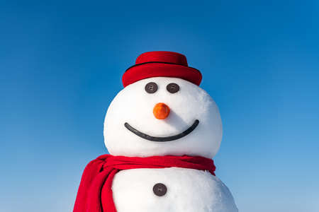 Funny snowman in stylish red hatの写真素材