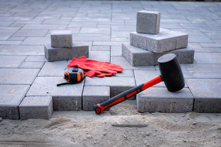 The master in gloves lays paving stonesの写真素材