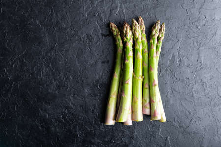 Green asparagus sprout on black boardの写真素材