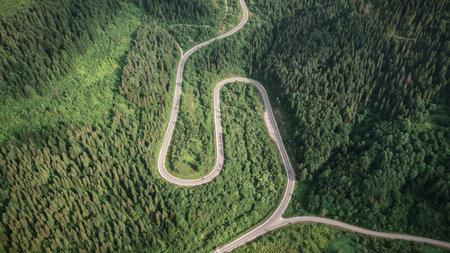 Flight over the summer mountains with mountain road serpentineの写真素材