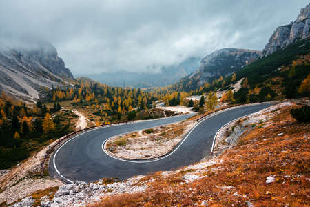 Winding mountains road leading to Three peaks of Lavaredoの写真素材