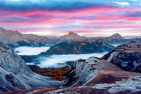Incredible panoramical view in the foggy morning Dolomites mountainsの写真素材